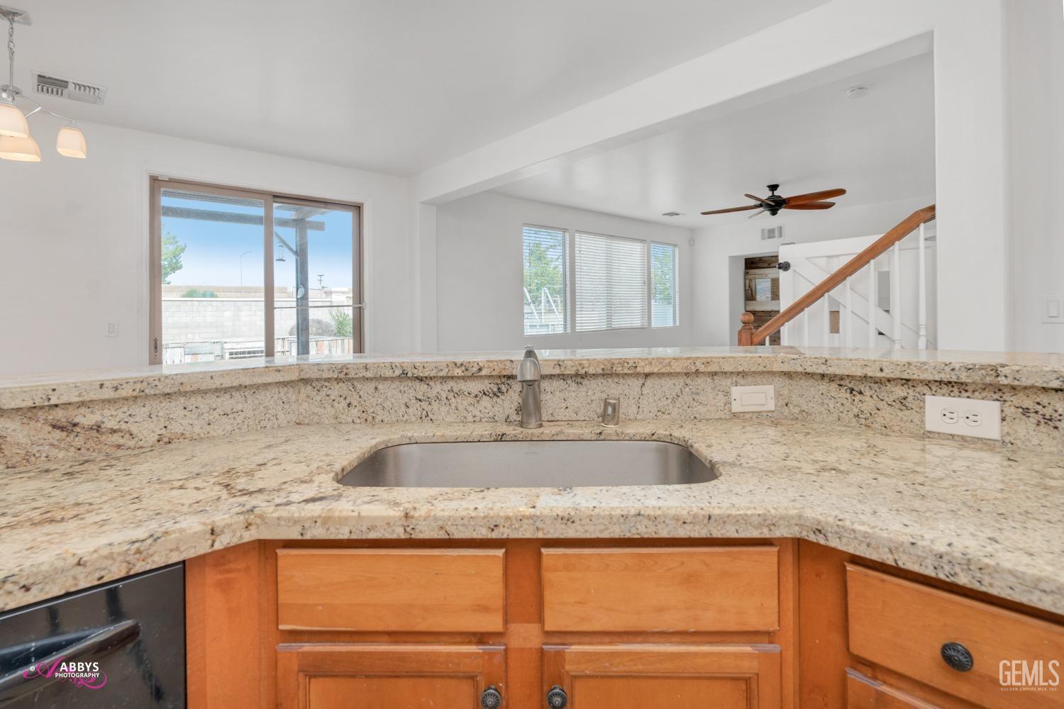 Undisclosed Address Bakersfield, CA 93312 - Photo 24 of 44 a kitchen with granite countertop a sink and a window