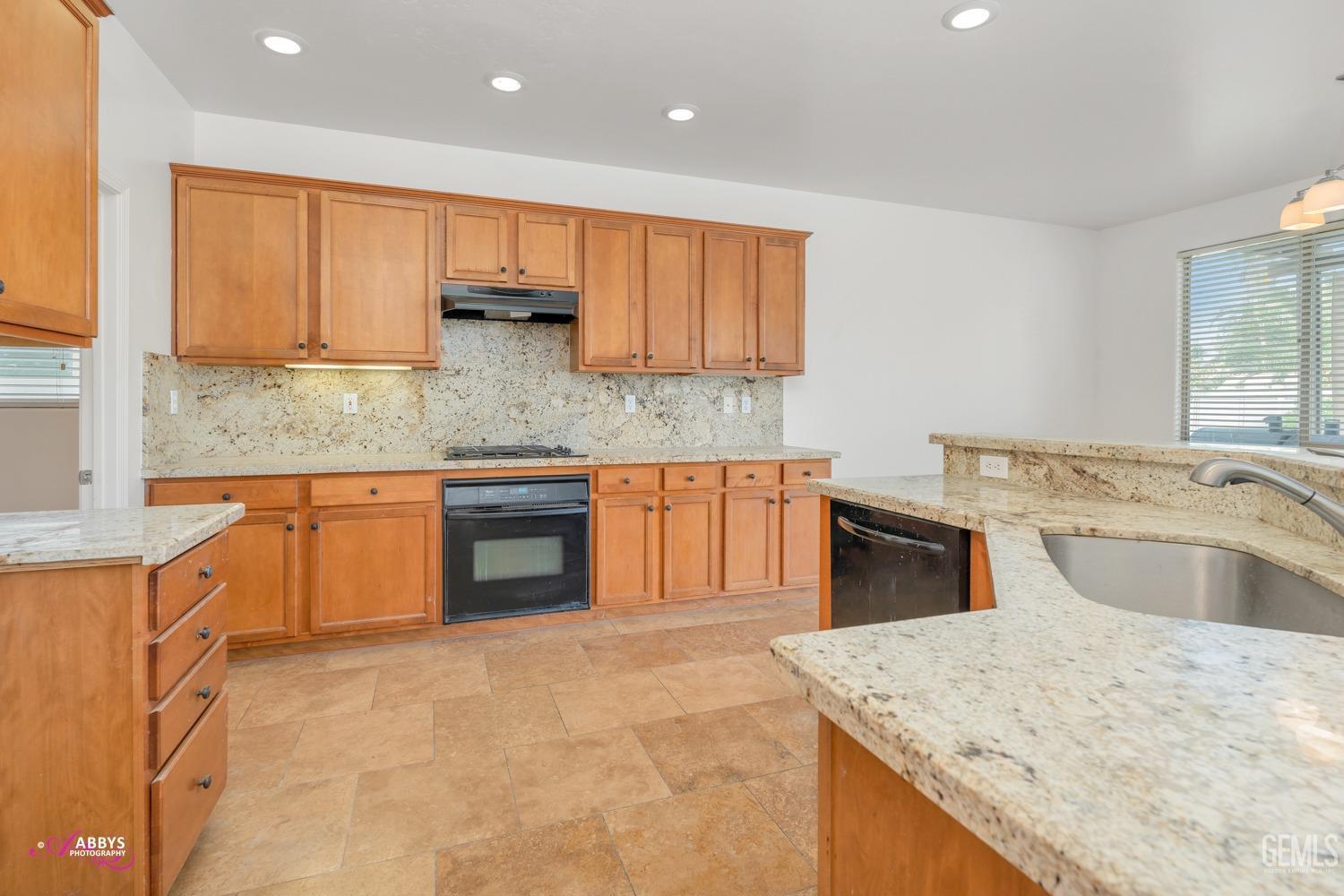 Undisclosed Address Bakersfield, CA 93312 - Photo 25 of 44 a kitchen with stainless steel appliances granite countertop a sink and dishwasher a stove with wooden floors