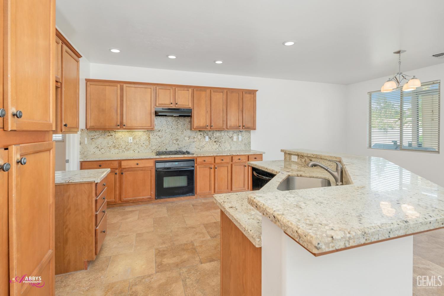 Undisclosed Address Bakersfield, CA 93312 - Photo 26 of 44 a kitchen with stainless steel appliances granite countertop a sink and a refrigerator