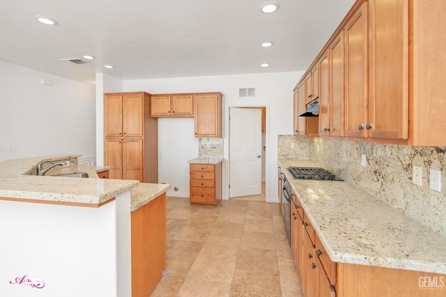 Undisclosed Address Bakersfield, CA 93312 - Photo 27 of 44 a kitchen with a sink stove and cabinets