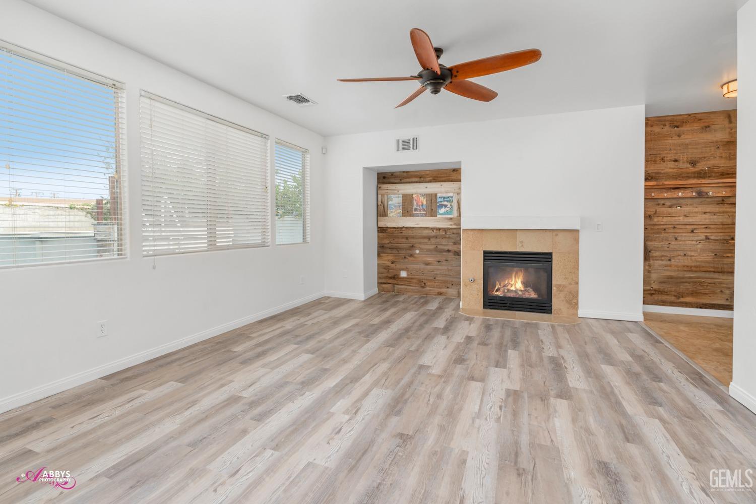 Undisclosed Address Bakersfield, CA 93312 - Photo 31 of 44 wooden floor in an empty room with a fireplace