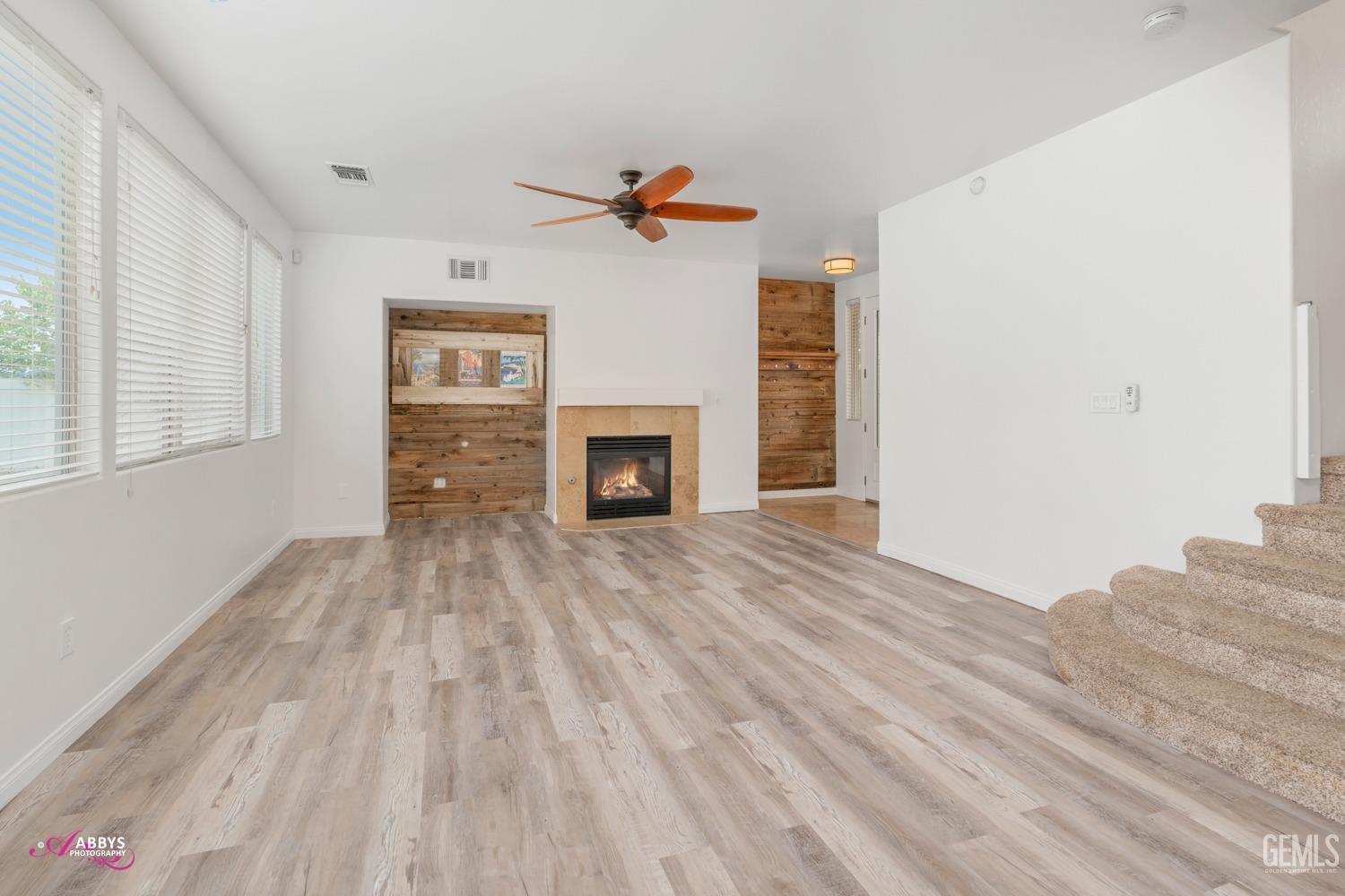 Undisclosed Address Bakersfield, CA 93312 - Photo 32 of 44 a view of empty room with wooden floor and fireplace