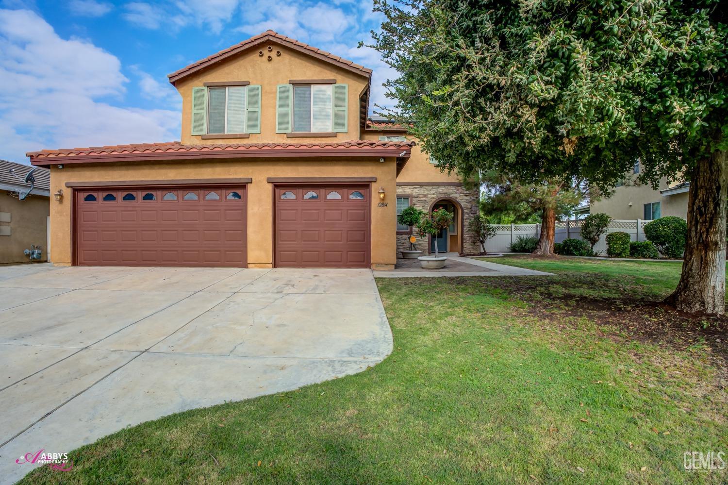 Undisclosed Address Bakersfield, CA 93312 - Photo 36 of 44 a front view of a house with a yard and garage
