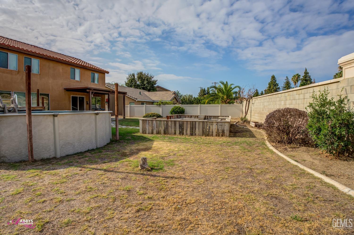 Undisclosed Address Bakersfield, CA 93312 - Photo 4 of 44 a view of a house with a yard