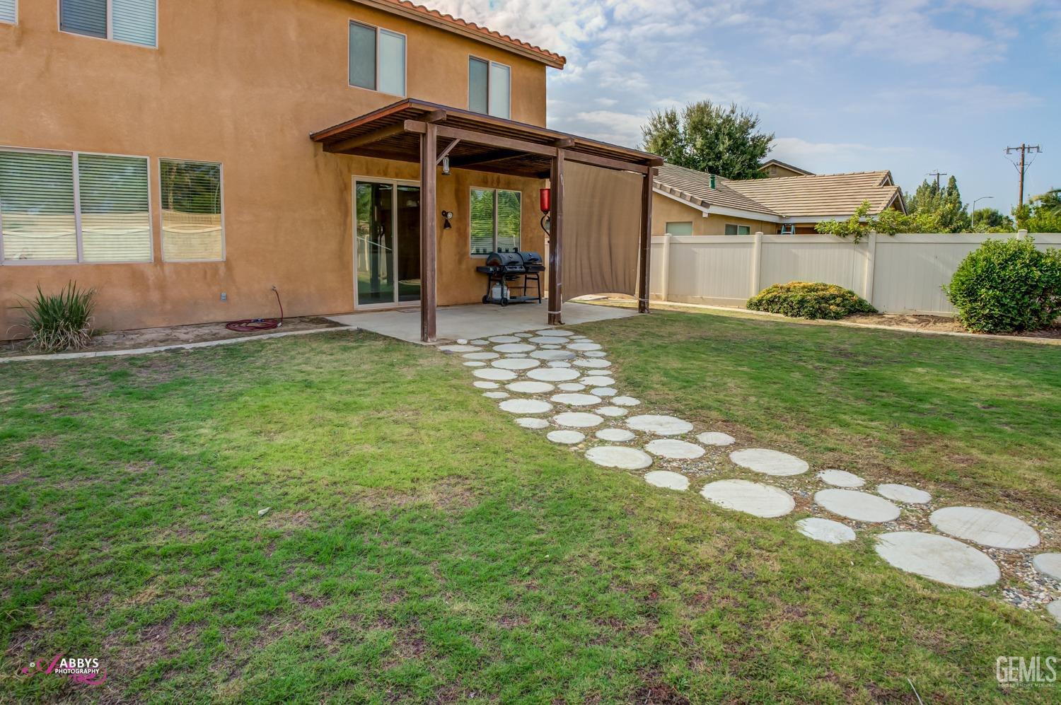 Undisclosed Address Bakersfield, CA 93312 - Photo 5 of 44 a front view of a house with garden