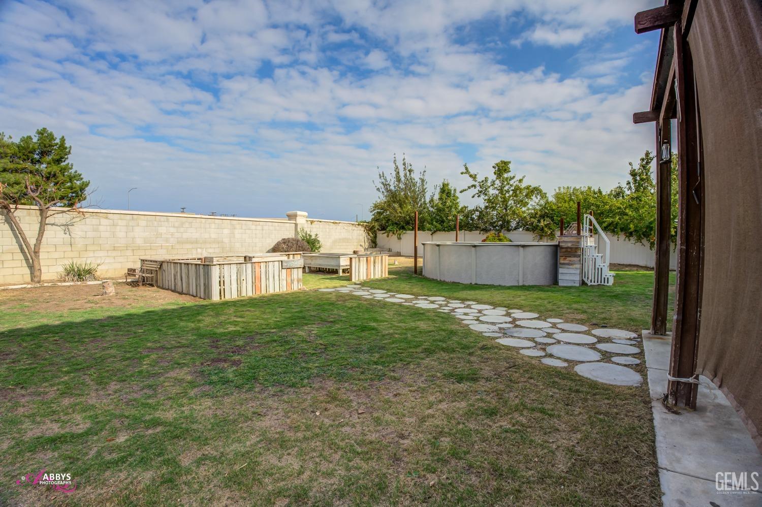 Undisclosed Address Bakersfield, CA 93312 - Photo 7 of 44 a backyard of a house with lots of green space