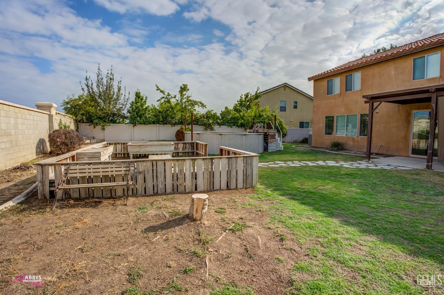Undisclosed Address Bakersfield, CA 93312 - Photo 8 of 44 a view of a house with a yard