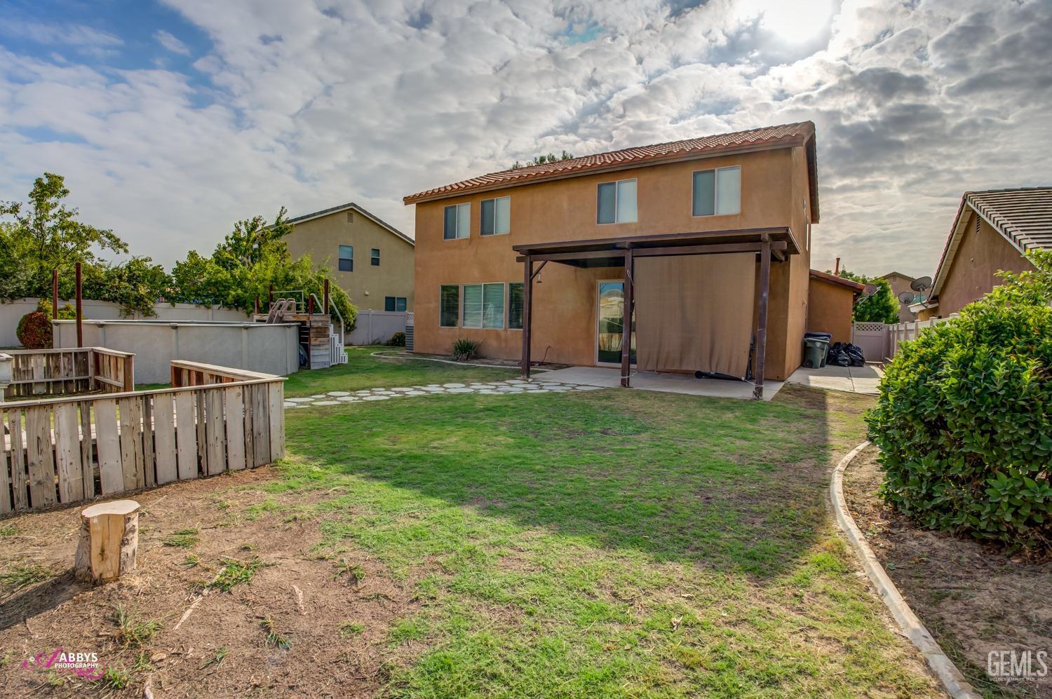 Undisclosed Address Bakersfield, CA 93312 - Photo 9 of 44 a front view of house with yard
