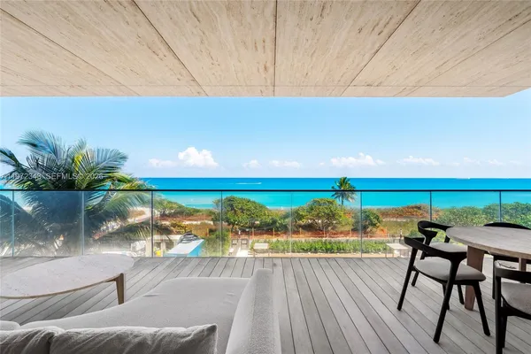 a balcony with table and chairs