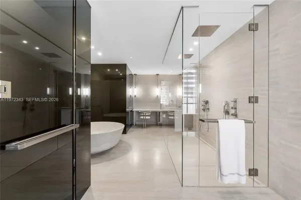 a bathroom with a tub and shower