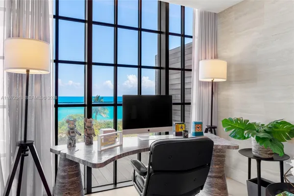 a living room with furniture tv and a potted plant
