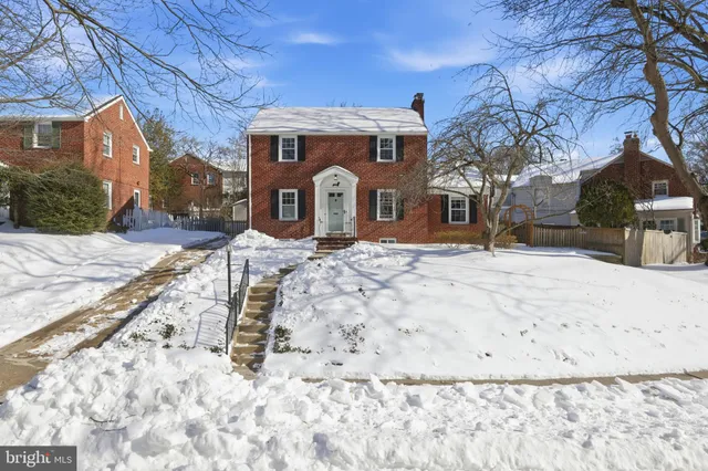 a view of a white house with a snow