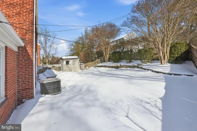 a view of a house with snow on the road
