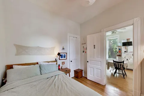 a bed room with a bed and a chair