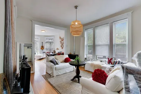 a living room with furniture and a chandelier