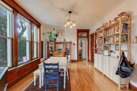 a bedroom with furniture and a book shelf