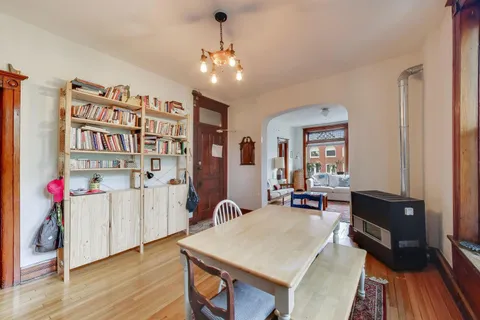 a living room with furniture a chandelier and a bookshelf
