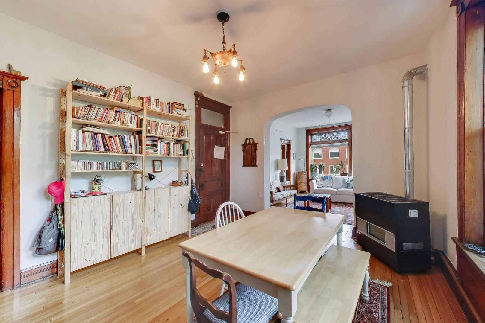 2701 West Haddon Avenue Chicago, IL 60622 - Photo 8 of 22 a living room with furniture a chandelier and a bookshelf