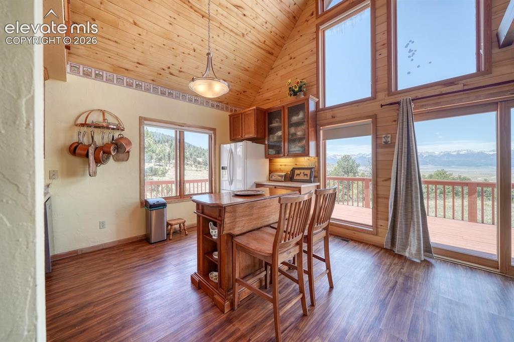 489 Excelsior Road Westcliffe, CO 81252 - Photo 3 of 34 a view of a dining room with furniture and wooden floor
