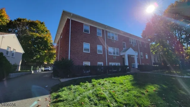 a brick building view with a yard