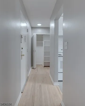 wooden floor in an empty room with a bathroom