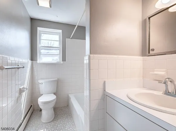 a bathroom with a toilet a sink and a bathtub
