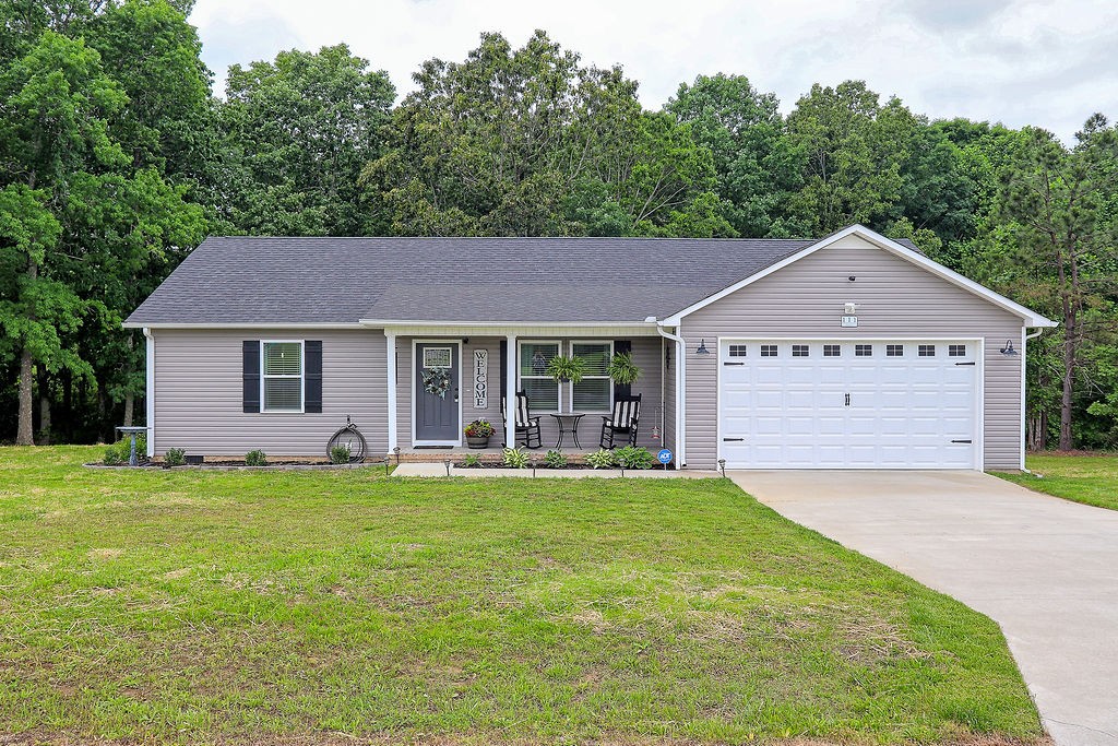 a front view of a house with a garden and yard