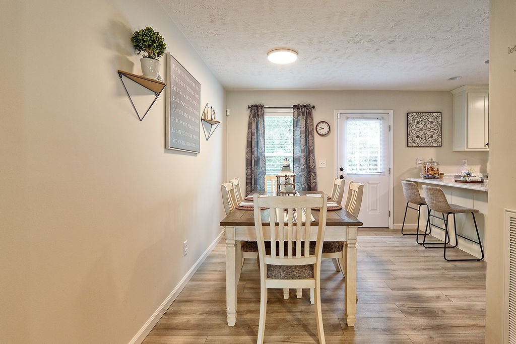 111 Heritage Hills Lane Hohenwald, TN 38462 - Photo 11 of 48 a view of a dining room with furniture and wooden floor