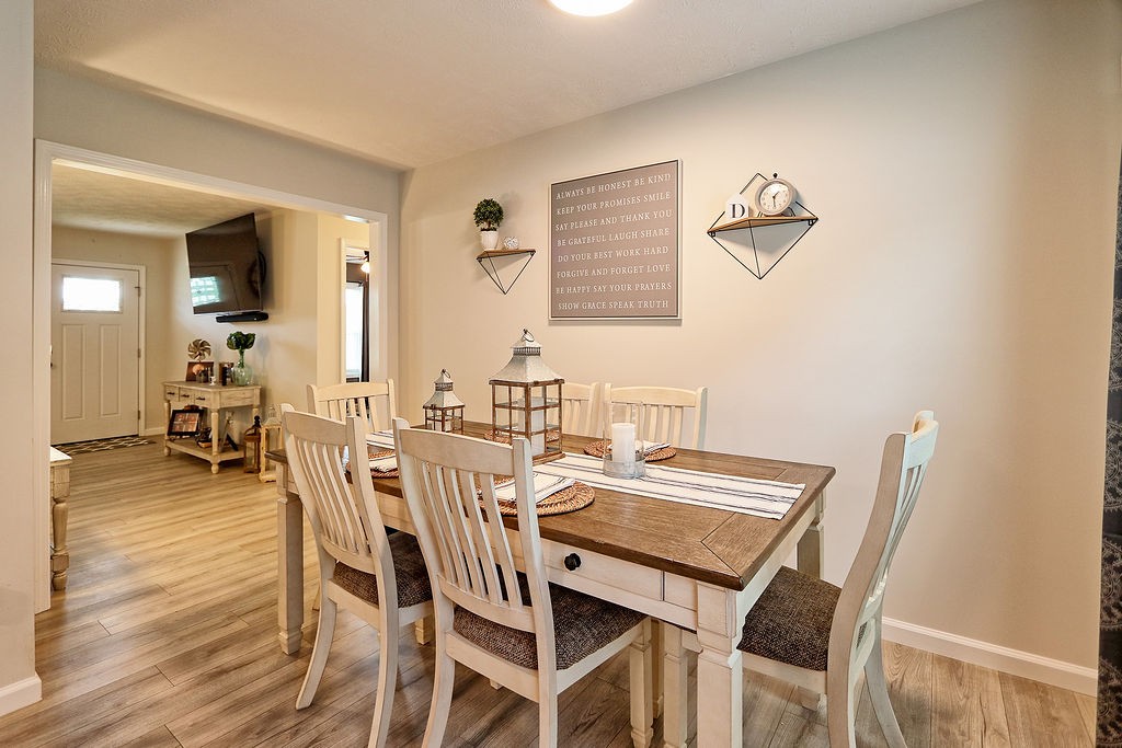 111 Heritage Hills Lane Hohenwald, TN 38462 - Photo 15 of 48 a view of a dining room with furniture and wooden floor