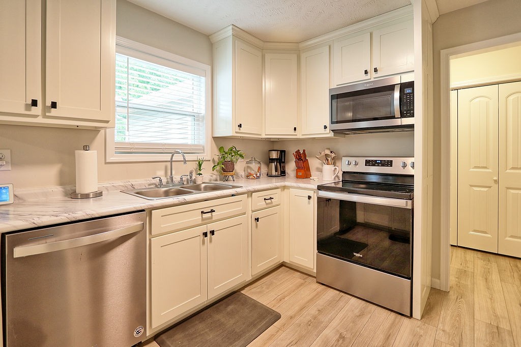 111 Heritage Hills Lane Hohenwald, TN 38462 - Photo 17 of 48 a kitchen with white cabinets and appliances
