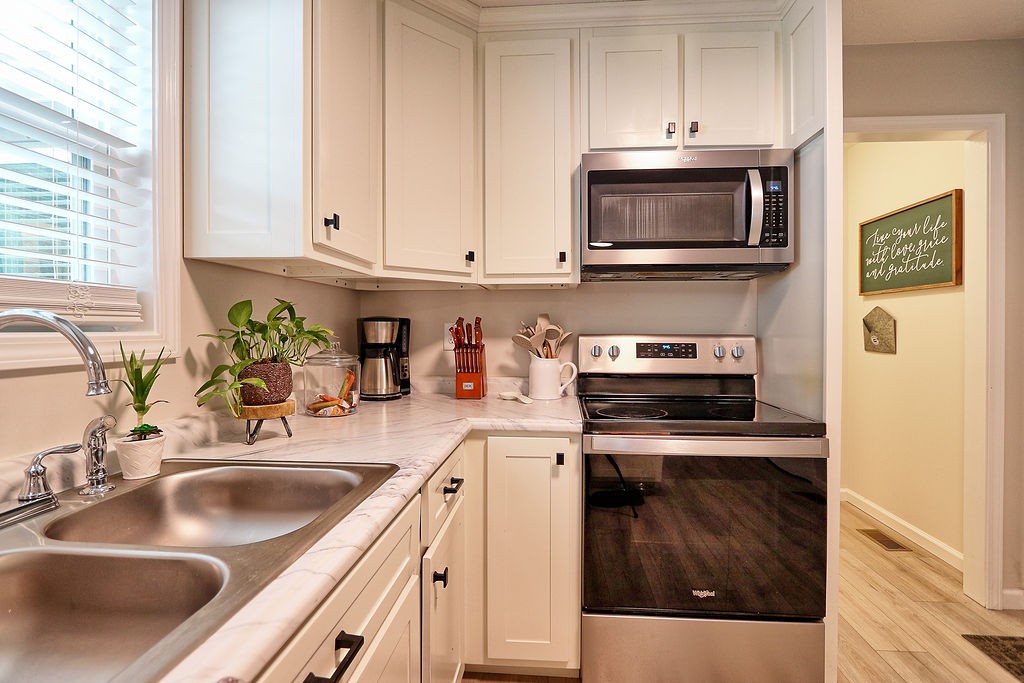 111 Heritage Hills Lane Hohenwald, TN 38462 - Photo 18 of 48 a kitchen with stainless steel appliances granite countertop a sink stove and microwave