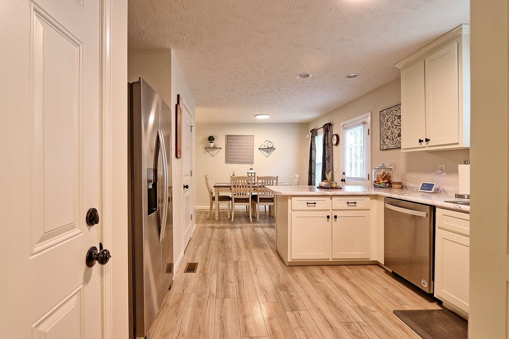 111 Heritage Hills Lane Hohenwald, TN 38462 - Photo 19 of 48 a kitchen with white cabinets and white appliances