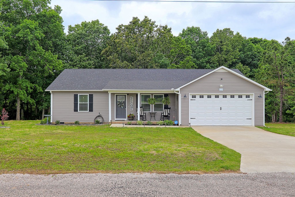 111 Heritage Hills Lane Hohenwald, TN 38462 - Photo 2 of 48 a front view of a house with a yard and garage