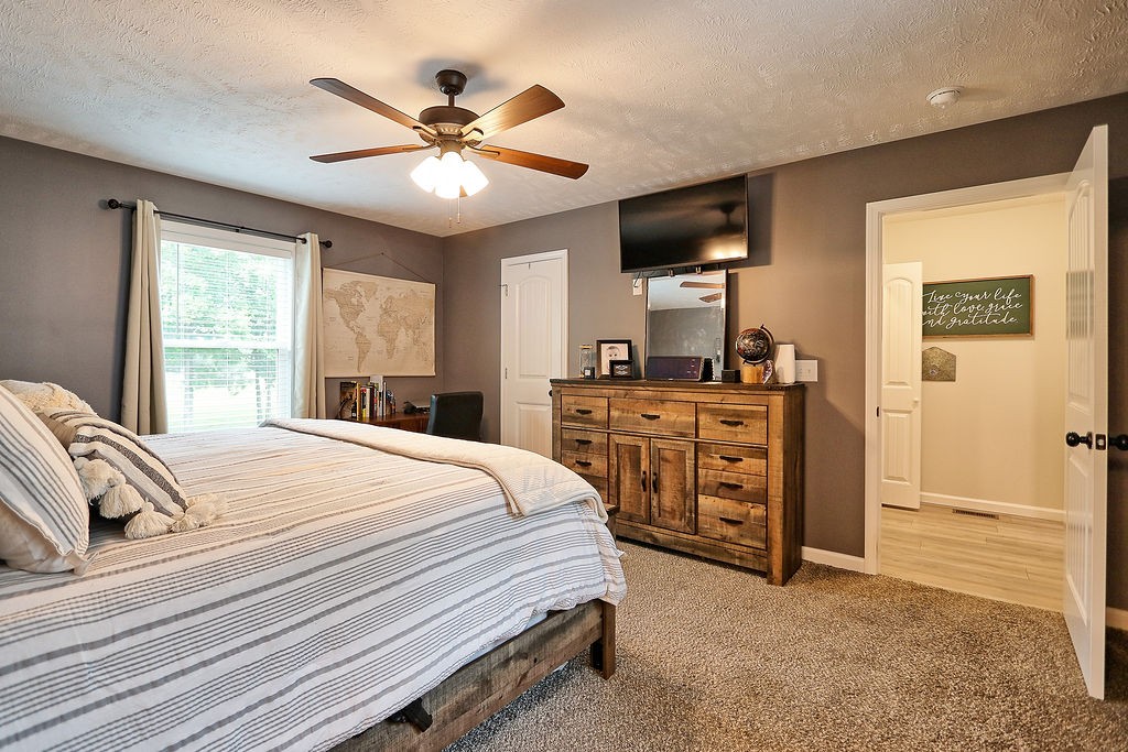 111 Heritage Hills Lane Hohenwald, TN 38462 - Photo 24 of 48 a bed room with a bed and a ceiling fan