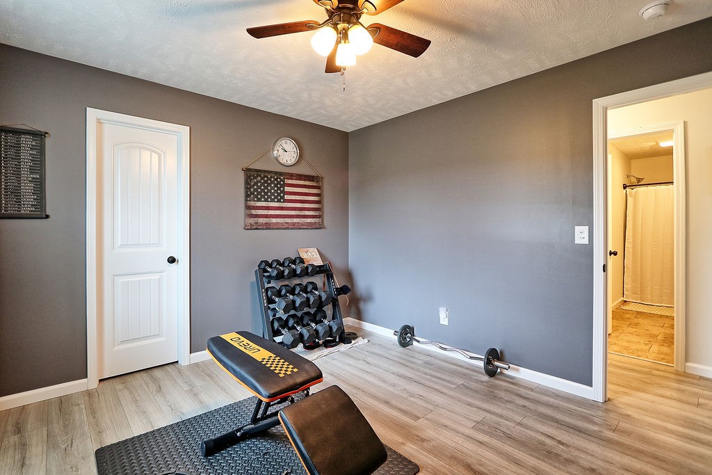 111 Heritage Hills Lane Hohenwald, TN 38462 - Photo 30 of 48 a bedroom with a bed and a chandelier