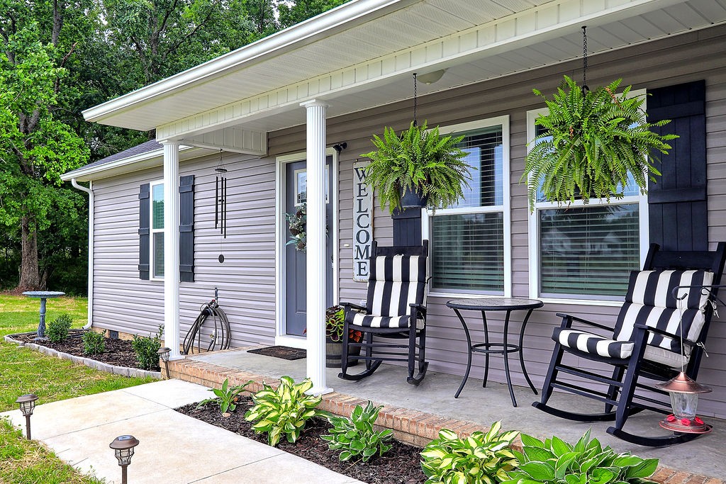 111 Heritage Hills Lane Hohenwald, TN 38462 - Photo 3 of 48 a front view of a house with porch and garden