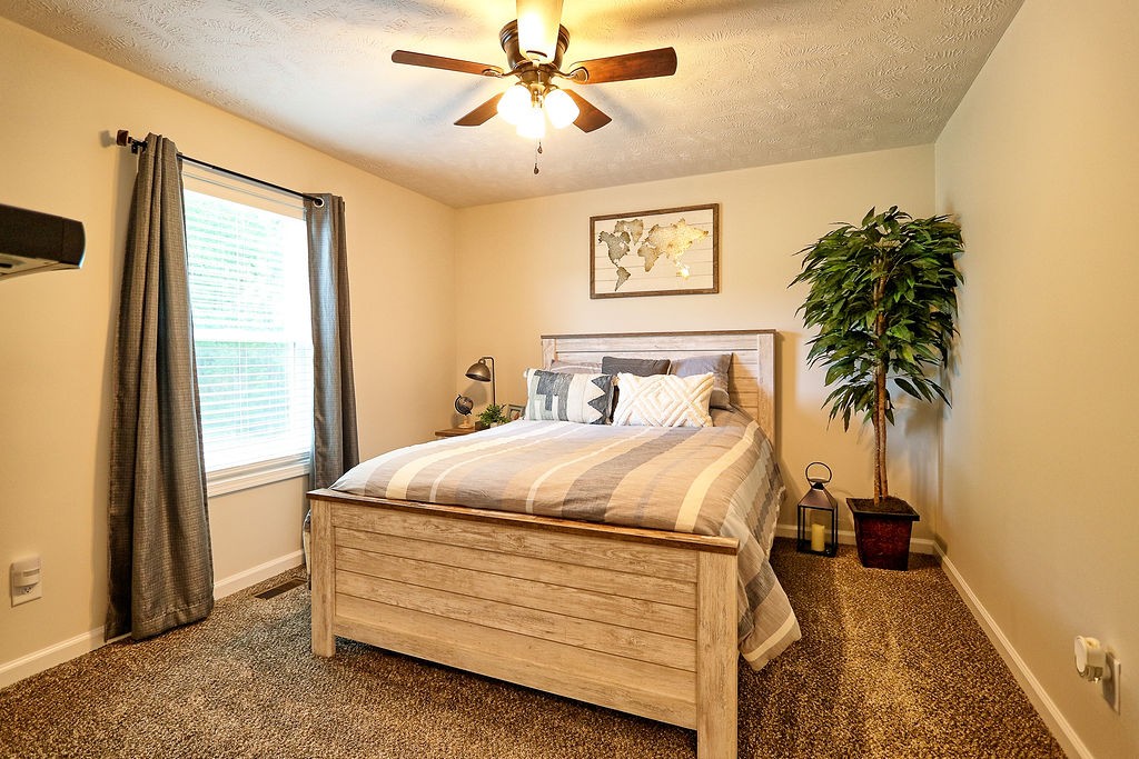 111 Heritage Hills Lane Hohenwald, TN 38462 - Photo 31 of 48 a bedroom with a bed and a window