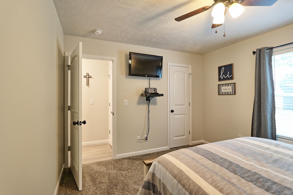 111 Heritage Hills Lane Hohenwald, TN 38462 - Photo 32 of 48 a bedroom with a bed and a flat screen tv
