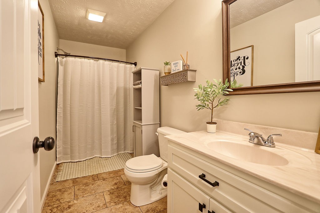 111 Heritage Hills Lane Hohenwald, TN 38462 - Photo 33 of 48 a bathroom with a granite countertop sink toilet and shower