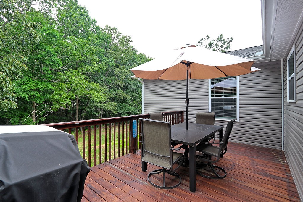111 Heritage Hills Lane Hohenwald, TN 38462 - Photo 40 of 48 a roof deck with table and chairs under an umbrella
