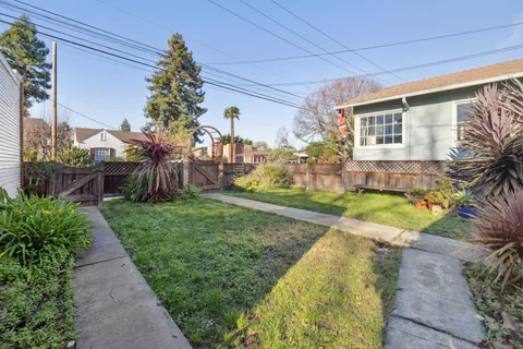 a view of a house with a backyard and a patio