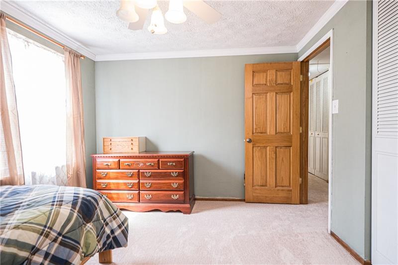 133 Old Ridge Road Coraopolis, PA 15108 - Photo 11 of 23 The master bedroom features new carpeting, a ceiling fan, nice sized closet and is enhanced with crown molding.Note the high quality interior wood paneled doors in this home.