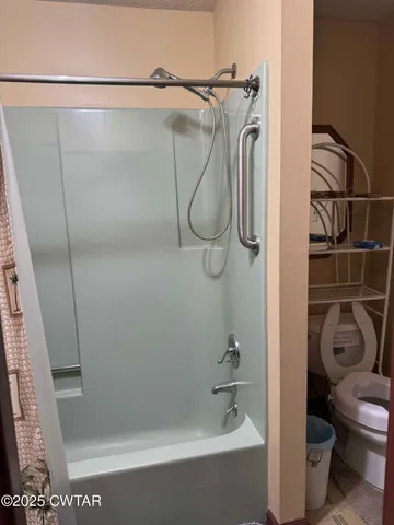 a bathroom with a shower and a toilet