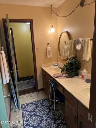 a bathroom with a sink mirror vanity and toilet