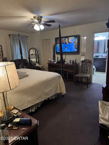 a bedroom with bed and a chandelier