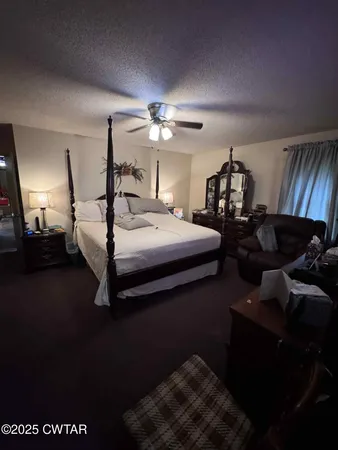 a bedroom with bed and a chandelier