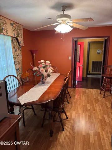 a view of a dining room with furniture and chandelier