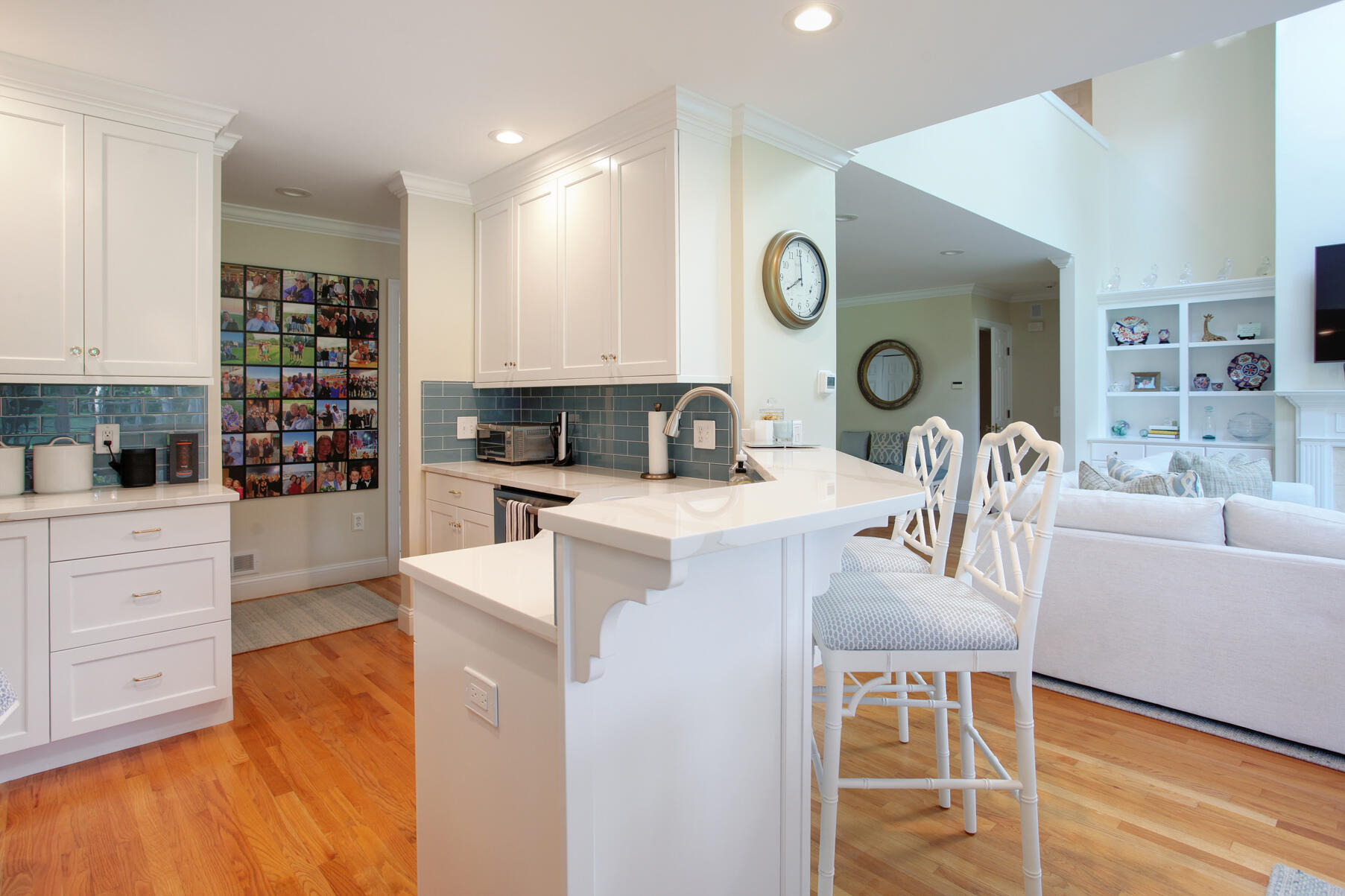 101 Reflection Drive Sandwich, MA 02563 - Photo 18 of 37 a kitchen with white cabinets and wooden floor