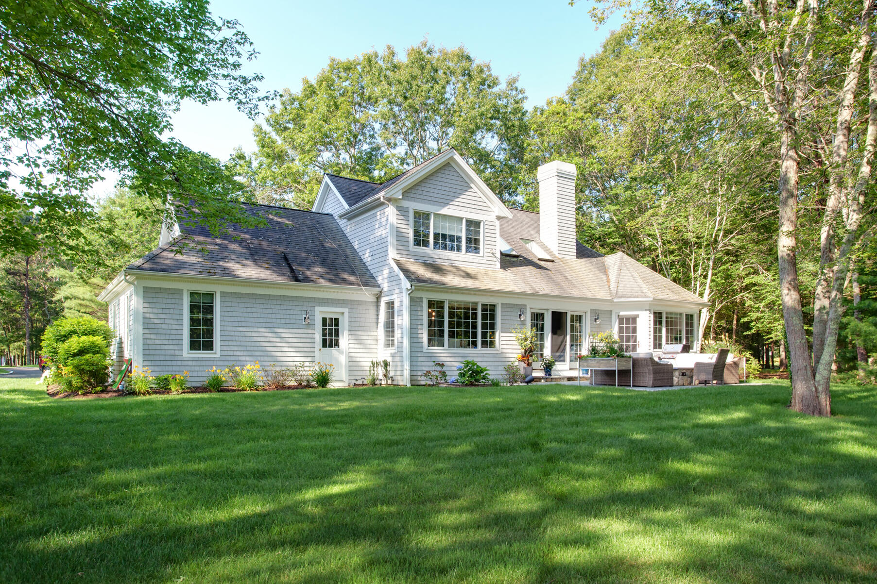 101 Reflection Drive Sandwich, MA 02563 - Photo 29 of 37 a front view of a house with a garden and trees