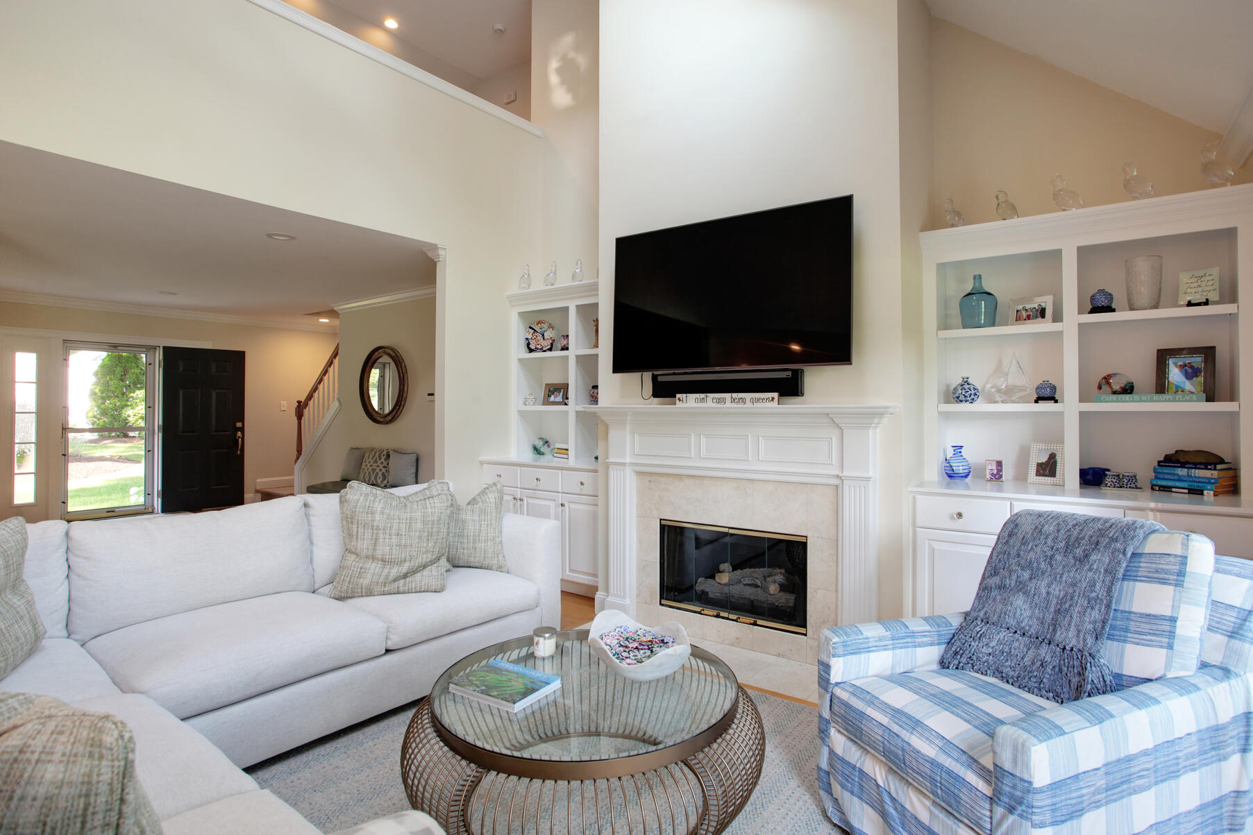 101 Reflection Drive Sandwich, MA 02563 - Photo 7 of 37 a living room with furniture a fireplace and a flat screen tv